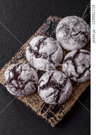 Chocolate crinkle cookies sprinkled with powdered sugar, homemade baking 129992118