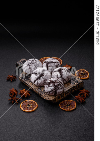 Chocolate crinkle cookies sprinkled with powdered sugar, homemade baking 129992127