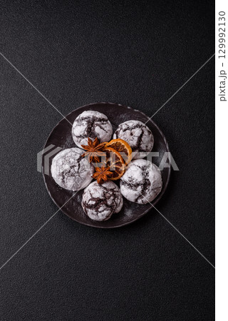 Chocolate crinkle cookies sprinkled with powdered sugar, homemade baking 129992130