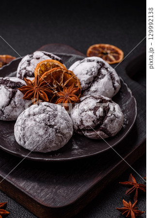 Chocolate crinkle cookies sprinkled with powdered sugar, homemade baking 129992138