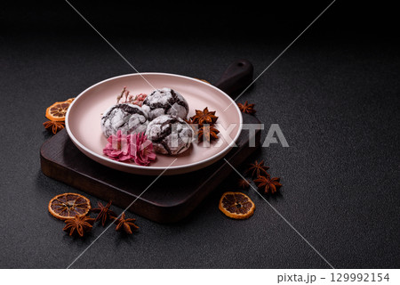 Chocolate crinkle cookies sprinkled with powdered sugar, homemade baking 129992154