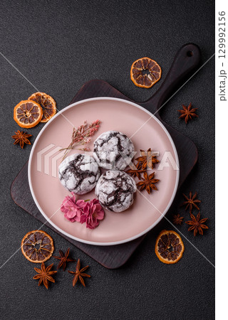 Chocolate crinkle cookies sprinkled with powdered sugar, homemade baking 129992156