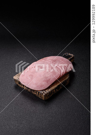 Sliced ham, meat or pork sausage for sandwiches. Cooked smoked prosciutto, ham 129992189