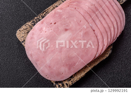 Sliced ham, meat or pork sausage for sandwiches. Cooked smoked prosciutto, ham 129992191