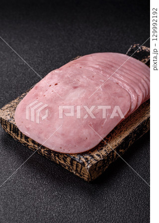Sliced ham, meat or pork sausage for sandwiches. Cooked smoked prosciutto, ham 129992192