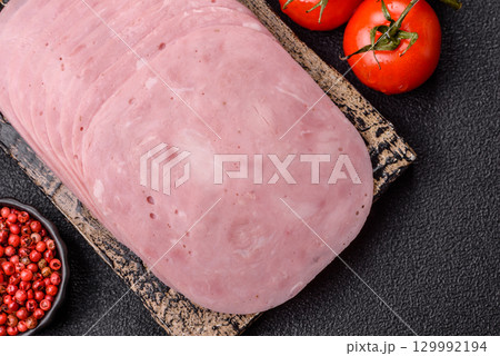 Sliced ham, meat or pork sausage for sandwiches. Cooked smoked prosciutto, ham Sliced ham, meat or pork sausage for sandwiches. Cooked smoked prosciutto, ham 129992194