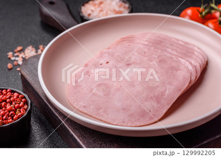 Sliced ham, meat or pork sausage for sandwiches. Cooked smoked prosciutto, ham 129992205