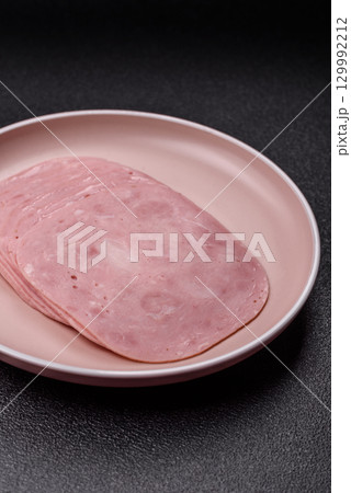 Sliced ham, meat or pork sausage for sandwiches. Cooked smoked prosciutto, ham Sliced ham, meat or pork sausage for sandwiches. Cooked smoked prosciutto, ham 129992212