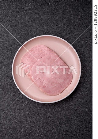 Sliced ham, meat or pork sausage for sandwiches. Cooked smoked prosciutto, ham 129992215
