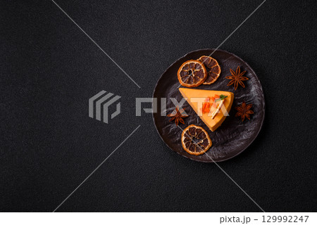 A slice of yellow cheesecake cake flavored with lemon and passion fruit 129992247