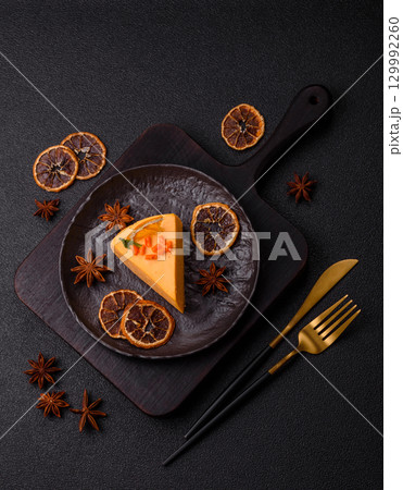 A slice of yellow cheesecake cake flavored with lemon and passion fruit 129992260