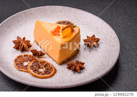 A slice of yellow cheesecake cake flavored with lemon and passion fruit A slice of yellow cheesecake cake flavored with lemon and passion fruit 129992270