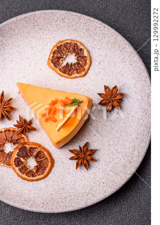 A slice of yellow cheesecake cake flavored with lemon and passion fruit A slice of yellow cheesecake cake flavored with lemon and passion fruit 129992272