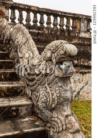 Intricately carved stone dragon sculpture on stair railing in Hue Imperial City Vietnam Intricately carved stone dragon sculpture on stair railing in Hue Imperial City Vietnam 129992393