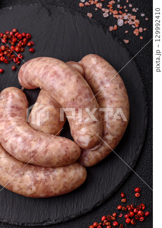 Raw meat sausages made from beef or pork, fresh meat for barbecuing or grilling. Raw sausages 129992410