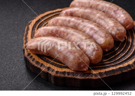 Raw meat sausages made from beef or pork, fresh meat for barbecuing or grilling. Raw sausages Raw meat sausages made from beef or pork, fresh meat for barbecuing or grilling. Raw sausages 129992452