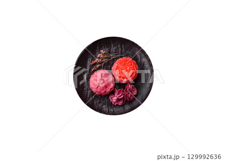 Chinese mooncake is an Asian sweet dessert. Asian mooncake as a background for your design 129992636