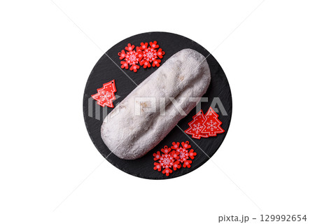 Christmas Stollen, a German sweet cake with marzipan and fruit. Winter Christmas Stollen Christmas Stollen, a German sweet cake with marzipan and fruit. Winter Christmas Stollen 129992654
