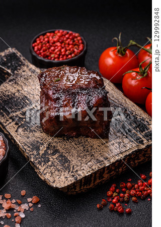 Grilled beef steak meat with salt and pepper. Beef steak grilled on a barbecue 129992848