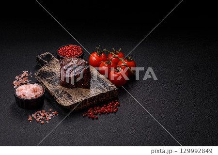 Grilled beef steak meat with salt and pepper. Beef steak grilled on a barbecue Grilled beef steak meat with salt and pepper. Beef steak grilled on a barbecue 129992849