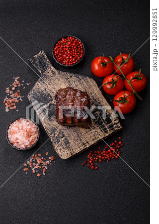 Grilled beef steak meat with salt and pepper. Beef steak grilled on a barbecue Grilled beef steak meat with salt and pepper. Beef steak grilled on a barbecue 129992851