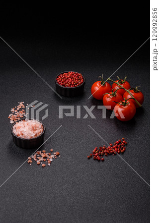 Ingredients for cooking cherry tomatoes, salt, spices and herbs Ingredients for cooking cherry tomatoes, salt, spices and herbs 129992856