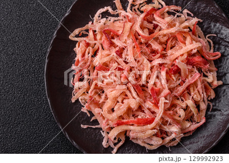 Food, dried squid in shavings or chopped as snacks or jerky. Snack dried squid for beer Food, dried squid in shavings or chopped as snacks or jerky. Snack dried squid for beer 129992923