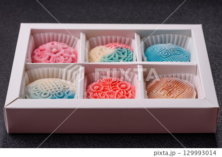 Chinese mooncake is an Asian sweet dessert. Asian mooncake as a background for your design 129993014