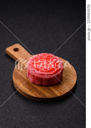 Chinese mooncake is an Asian sweet dessert. Asian mooncake as a background for your design Chinese mooncake is an Asian sweet dessert. Asian mooncake as a background for your design 129993026