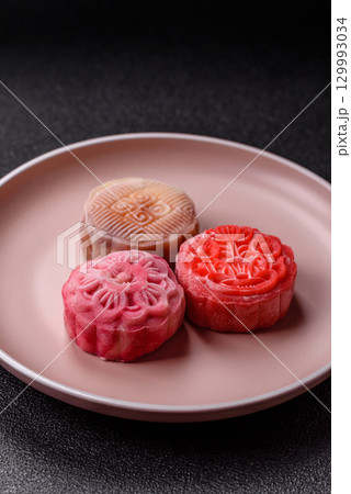 Chinese mooncake is an Asian sweet dessert. Asian mooncake as a background for your design 129993034