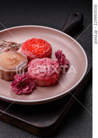 Chinese mooncake is an Asian sweet dessert. Asian mooncake as a background for your design 129993038