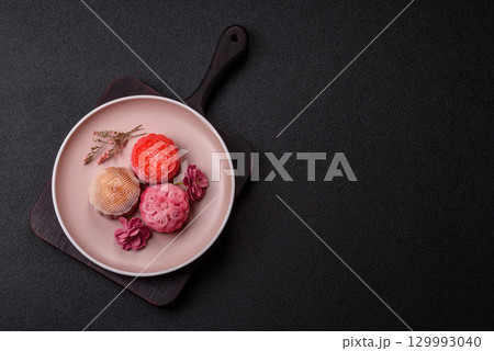 Chinese mooncake is an Asian sweet dessert. Asian mooncake as a background for your design Chinese mooncake is an Asian sweet dessert. Asian mooncake as a background for your design 129993040