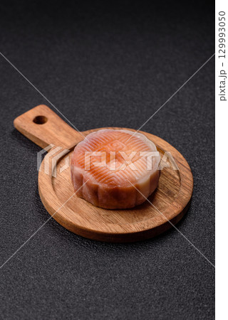 Chinese mooncake is an Asian sweet dessert. Asian mooncake as a background for your design 129993050