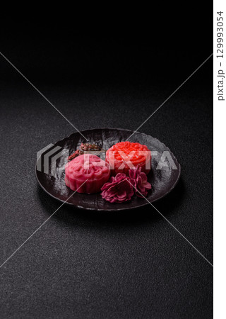 Chinese mooncake is an Asian sweet dessert. Asian mooncake as a background for your design Chinese mooncake is an Asian sweet dessert. Asian mooncake as a background for your design 129993054