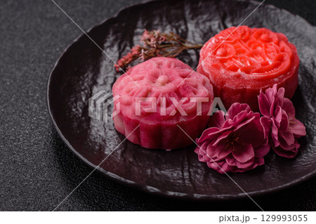 Chinese mooncake is an Asian sweet dessert. Asian mooncake as a background for your design Chinese mooncake is an Asian sweet dessert. Asian mooncake as a background for your design 129993055