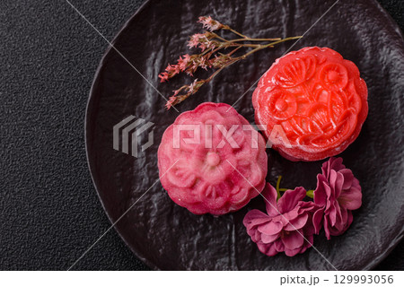 Chinese mooncake is an Asian sweet dessert. Asian mooncake as a background for your design Chinese mooncake is an Asian sweet dessert. Asian mooncake as a background for your design 129993056