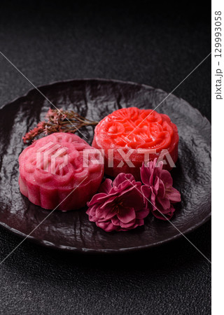 Chinese mooncake is an Asian sweet dessert. Asian mooncake as a background for your design 129993058
