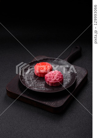 Chinese mooncake is an Asian sweet dessert. Asian mooncake as a background for your design 129993066