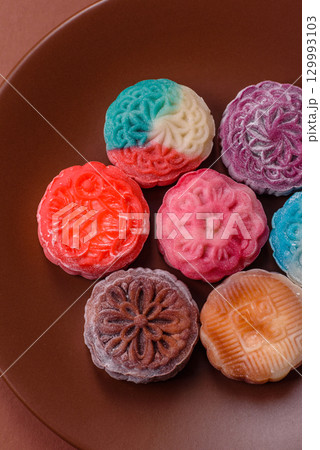 Chinese mooncake is an Asian sweet dessert. Asian mooncake as a background for your design 129993103