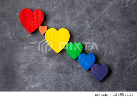 Rainbow colors wood hearts on the stone black background. Lgbt flag.  129993115