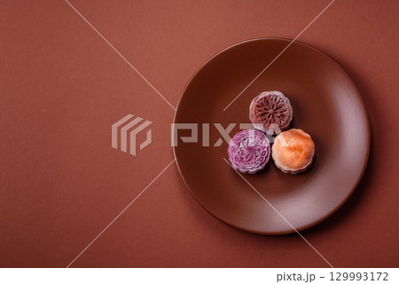 Chinese mooncake is an Asian sweet dessert. Asian mooncake as a background for your design Chinese mooncake is an Asian sweet dessert. Asian mooncake as a background for your design 129993172