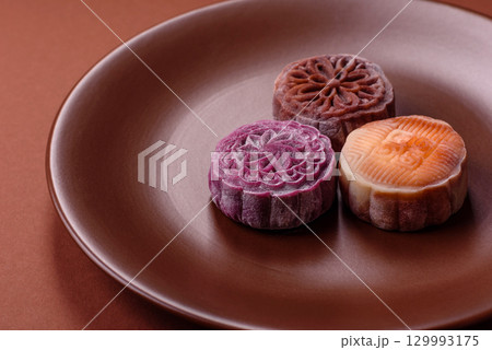 Chinese mooncake is an Asian sweet dessert. Asian mooncake as a background for your design Chinese mooncake is an Asian sweet dessert. Asian mooncake as a background for your design 129993175