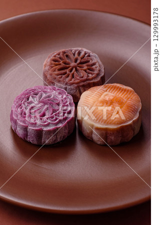 Chinese mooncake is an Asian sweet dessert. Asian mooncake as a background for your design 129993178