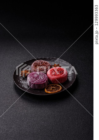 Chinese mooncake is an Asian sweet dessert. Asian mooncake as a background for your design 129993363