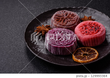 Chinese mooncake is an Asian sweet dessert. Asian mooncake as a background for your design 129993364