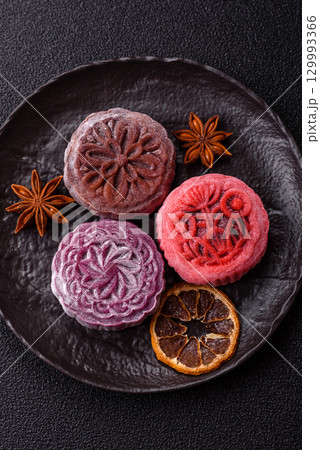 Chinese mooncake is an Asian sweet dessert. Asian mooncake as a background for your design Chinese mooncake is an Asian sweet dessert. Asian mooncake as a background for your design 129993366