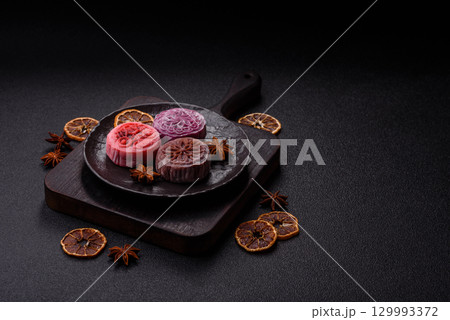 Chinese mooncake is an Asian sweet dessert. Asian mooncake as a background for your design Chinese mooncake is an Asian sweet dessert. Asian mooncake as a background for your design 129993372