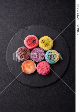 Chinese mooncake is an Asian sweet dessert. Asian mooncake as a background for your design Chinese mooncake is an Asian sweet dessert. Asian mooncake as a background for your design 129993378