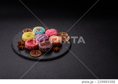 Chinese mooncake is an Asian sweet dessert. Asian mooncake as a background for your design Chinese mooncake is an Asian sweet dessert. Asian mooncake as a background for your design 129993388