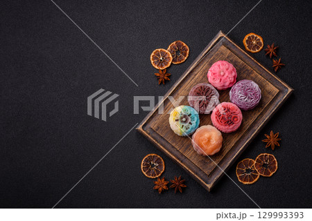 Chinese mooncake is an Asian sweet dessert. Asian mooncake as a background for your design 129993393